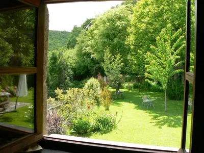 a view of a garden from a window at El Taller De La Seda in Avedillo de Sanabria