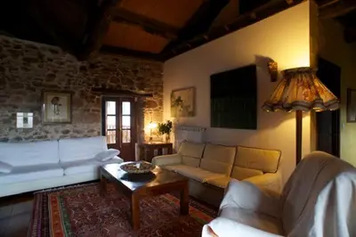 a living room with a couch and a table at El Taller De La Seda in Avedillo de Sanabria