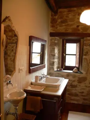 a bathroom with a sink and a mirror at El Taller De La Seda in Avedillo de Sanabria