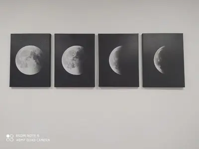 four panels of the moon four paintings at Huellas Albergue-Turístico in Portomarin