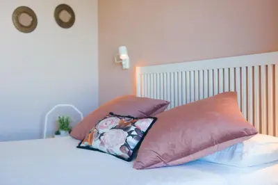 a bed with two pillows on top of it at Carrioza Alojamiento Turístico in Parada del Sil