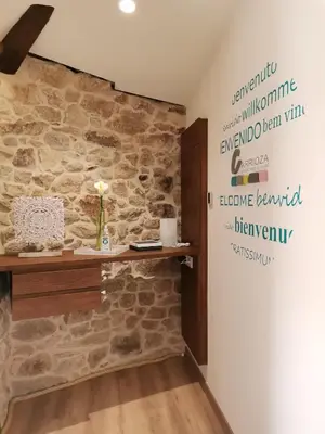 a room with a stone wall with a shelf on it at Carrioza Alojamiento Turístico in Parada del Sil