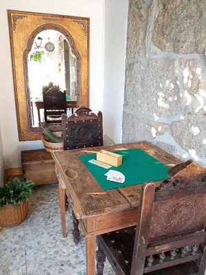 a room with a wooden table and a mirror at Casa MiraXurés con vistas a la Sierra del Xurés in Ourense