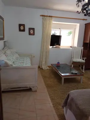 a bedroom with a bed and a coffee table at Casa MiraXurés con vistas a la Sierra del Xurés in Ourense