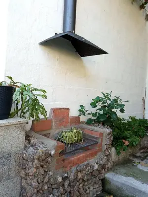 a bunch of bananas sitting on a brick grill at Casa MiraXurés con vistas a la Sierra del Xurés in Ourense