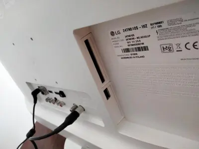 a book with a cord plugged into a electrical outlet at Piso con piscina en Sada in Sada