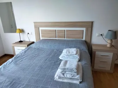 a bedroom with a bed with towels on it at Piso con piscina en Sada in Sada