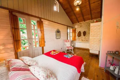 a bedroom with a large bed in a house at Cas do Mestre - Casa rural con Encanto in Pontevedra
