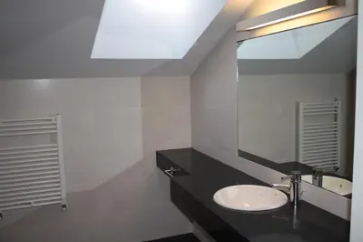 a bathroom with a sink and a mirror at Hostal Tres Campanas in Villafranca del Bierzo