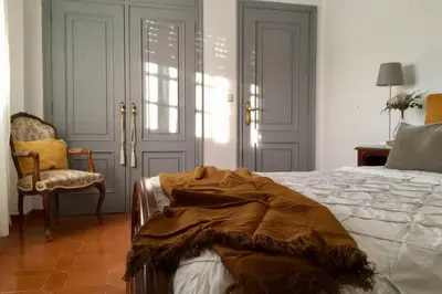 a bedroom with a bed with a blanket on it at Casa Rural Picape in Pedre