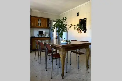 a dining room with a wooden table and chairs at Casa Rural Picape in Pedre
