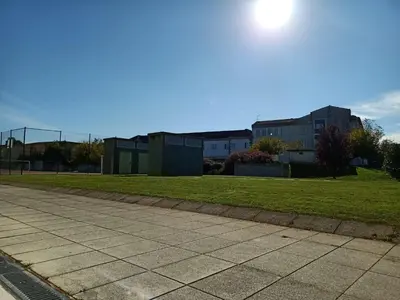 a sidewalk in front of a park with buildings at Pensión Boutique ADMERA in Santiago de Compostela