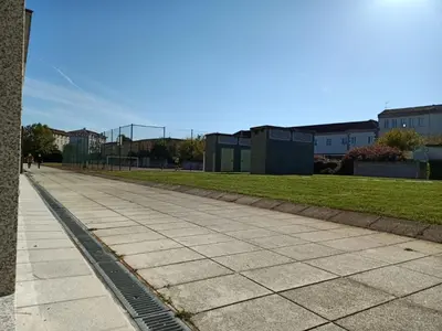 a sidewalk in front of a park with buildings at Pensión Boutique ADMERA in Santiago de Compostela