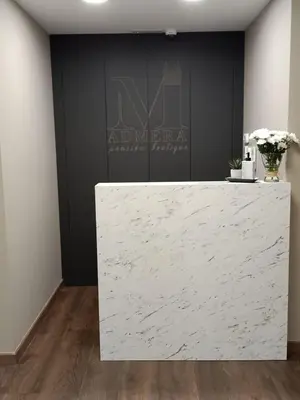 a white marble counter in a room with a black wall at Pensión Boutique ADMERA in Santiago de Compostela