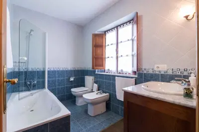 a bathroom with a toilet and a tub and a sink at apartamentos castrovaselle nº2 in Castrovaselle