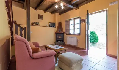 a living room with two chairs and a wood stove at apartamentos castrovaselle nº2 in Castrovaselle