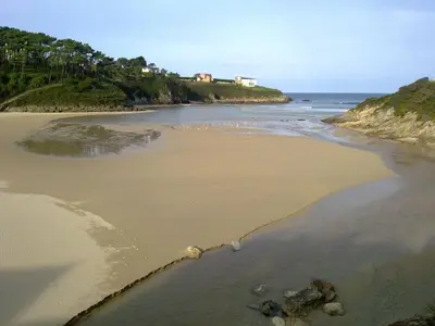 a view of a beach with a house on a hill at apartamentos castrovaselle nº2 in Castrovaselle