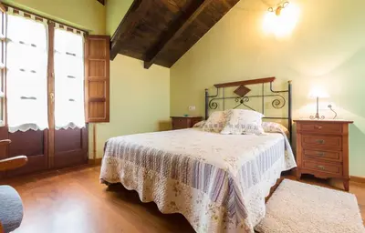 a bedroom with a bed and a dresser and a window at apartamentos castrovaselle nº2 in Castrovaselle