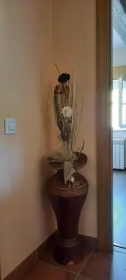 a vase with a plant sitting on top of a table at A Quinta Das Maceiras in San Miguel de Castro