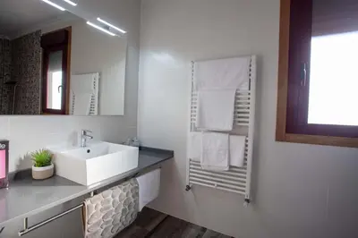 a white bathroom with a sink and a mirror at PENSIÓN CASA ANTONIO in Pantón