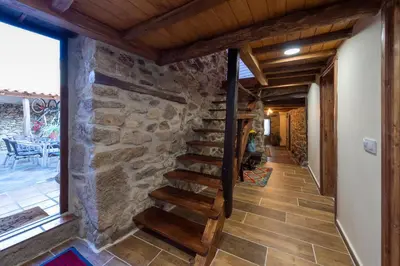 a staircase in a house with a stone wall at Casa Pion in Sober