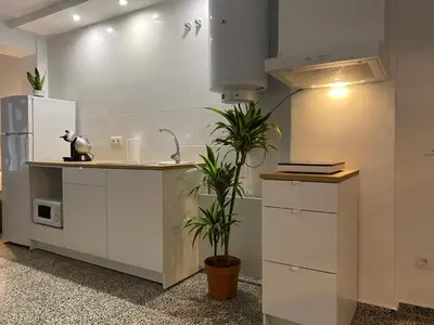 a kitchen with a sink and a refrigerator at Apartamento Padrón Centro P2 by URent in Padrón