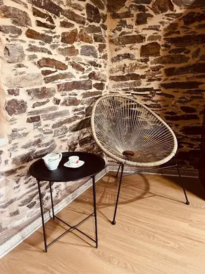 a table with a chair and a table with cups on it at Casa rural entre Santiago Compostela y La Coruña in Ordes