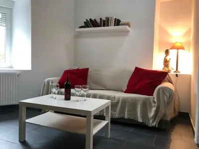 a living room with a couch and a table with wine glasses at casa ferreirua in Ferreirúa