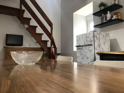 a living room with a wooden table and a television at casa ferreirua in Ferreirúa