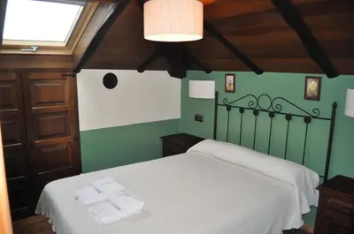 a bed in a room with towels on it at APARTAMENTOS RURALES CASTRO DE VILAOSENDE in Ribadeo