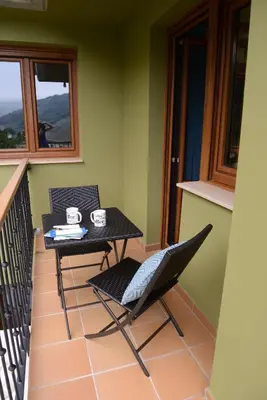 a balcony with a table and chairs on a balcony at El Mirador De Limes in Cangas del Narcea