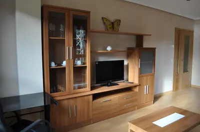 a large wooden entertainment center with a television in it at El Mirador De Limes in Cangas del Narcea