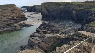 an aerial view of a beach with rocks and the ocean at Apartamentos Shalom Ribadeo in Ribadeo