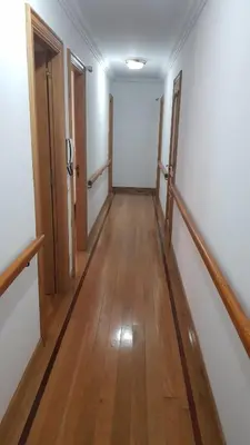 a hallway of an empty room with wooden floors at Apartamentos Shalom Ribadeo in Ribadeo