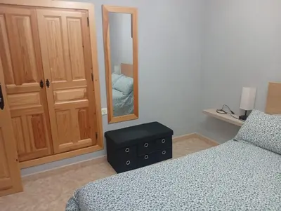 a bedroom with a bed and a dresser and a mirror at Casa familiar con finca privada (Orolterra) in Viveiro