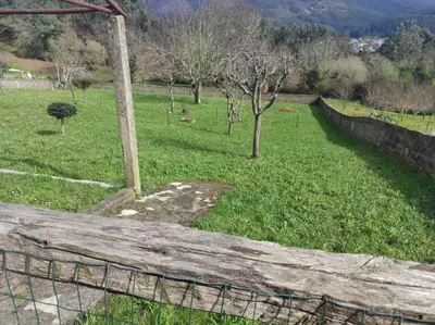 a fence in front of a field of grass at Casa familiar con finca privada (Orolterra) in Viveiro