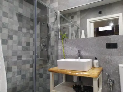 a bathroom with a sink and a shower at Apartamentos turísticos o palomar in Villalba