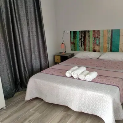 a bedroom with two beds with white towels on them at Vivienda uso turistico Los Nogales in Foz