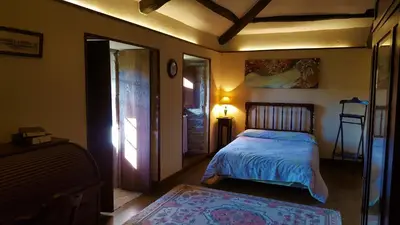a bedroom with a bed and a lamp in it at Casa Berdeal in Santa María