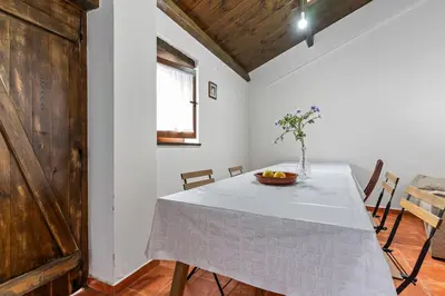 a dining room with a table with a bowl of fruit on it at Apartamentos Turisticos As Cetareas in Rinlo