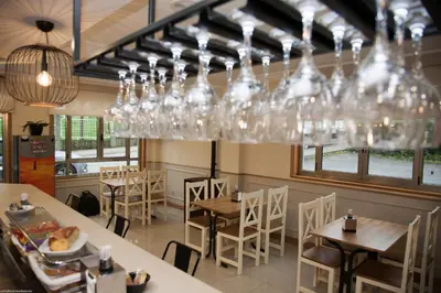 a restaurant with a bunch of glasses hanging from the ceiling at Hotel San Briz in A Pontenova