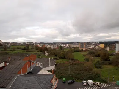 a view of a city with cars and buildings at U-Hotel Darío Lugo in Lugo