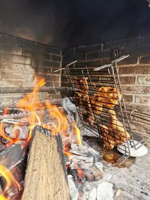 a grill with a bunch of food on it at Habitación Cuadruple con derecho a Barbacoa y patio in Navia de Suarna
