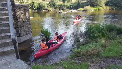a group of people in kayaks on a river at Habitación Cuadruple con derecho a Barbacoa y patio in Navia de Suarna
