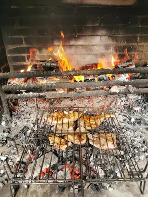 a grill with a bunch of food on it at Habitación Cuadruple con derecho a Barbacoa y patio in Navia de Suarna