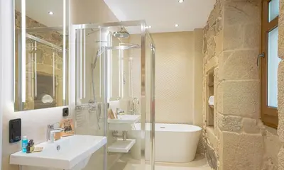 a bathroom with a shower and a sink and a tub at Hotel As Torres da Hermida in Monterroso