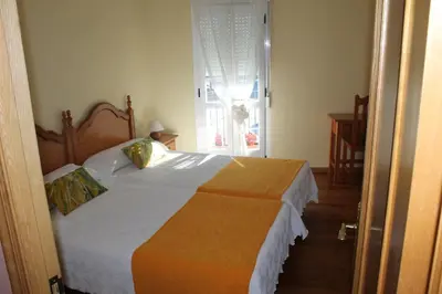 a bedroom with a bed and a window at Casa O Torgal in Parada del Sil