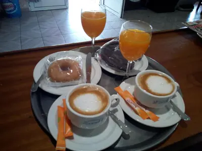 a tray with two cups of coffee and two glasses of orange juice at Arume in Bóveda