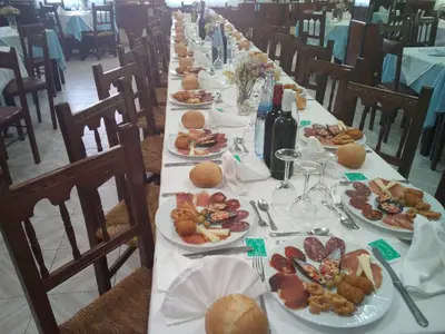a long table with plates of food on it at Arume in Bóveda