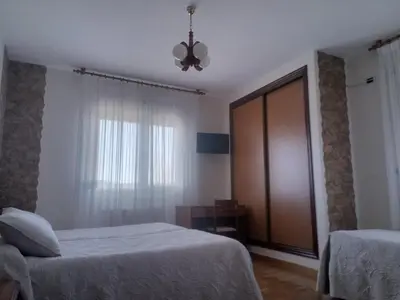 a bedroom with two beds and a ceiling fan at Arume in Bóveda